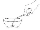 A hand holding a syringe with the needle pointing downward