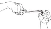 Black line drawing showing a hand holding a pair of scissors cutting a small object held by another hand