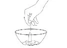 A hand holding a vial above a bowl to pour its liquid contents into it