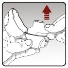 Two hands holding a white medical device with a red arrow pointing towards it