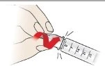 A hand rotating the top part of an injection pen, indicated by a curved red arrow, to adjust the dose