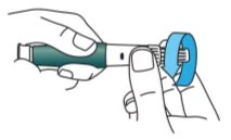 Two hands holding a cylindrical medical device to remove a blue protective cap using thumb pressure