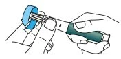 Two hands holding a cylindrical medical device with a blue cap, preparing for use