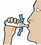 A hand holding a white medical device and bringing it close to a person's mouth, with two blue arrows indicating the movement towards