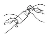 Two hands holding and operating a cylindrical medical device