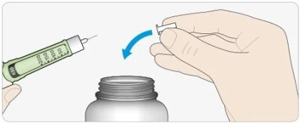 A hand holding a syringe with liquid while the