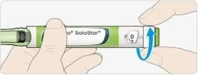 Two hands holding a SoloStar injection pen with a blue arrow indicating the rotation of the end part toward the