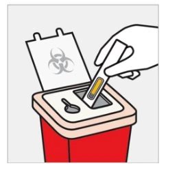 A hand inserting a yellow container with liquid into
