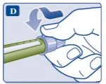 Una mano preme con il pollice verso il basso la parte superiore di un dispositivo medico cilindrico di colore verde e bianco