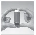 Two hands holding a dark cylindrical vial with a white cap vertically to show its shape and size