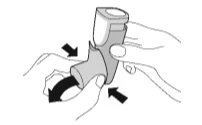 Two hands holding a medical device with black arrows indicating pressing motion and the