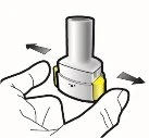 A hand holds a white and yellow cylindrical medical device with black arrows indicating a horizontal rotating movement