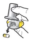 A hand holds a metallic container above a medical device, from which a yellow and white capsule emerges, indicated by a black arrow
