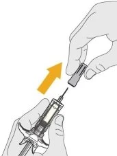Two hands removing the grey cap from the needle of a syringe with a yellow arrow pointing towards the needle