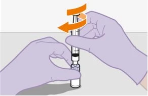 Two gloved hands holding a syringe with orange arrows indicating a rotational movement for