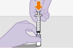 Two hands holding a graduated syringe with an orange arrow pointing downward indicating downward piston pressure for