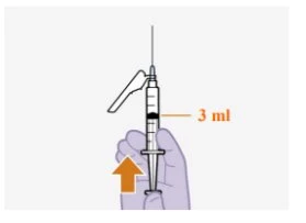 A hand holding a syringe with the needle pointing downward