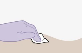 A purple-gloved hand gently lifting the