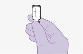 A gloved hand holding vertically a small white cylindrical container with a narrow base on a light background