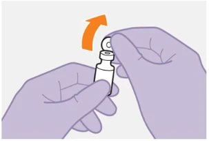 Two gloved hands lifting the cap off a small white vial following the direction of an orange arrow pointing upward