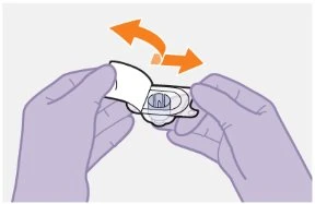 Two gloved hands holding a transparent white medical device with a curved orange arrow indicating a rotational movement