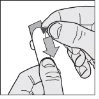 Two hands holding a finger with a downward-pointing arrow indicating the direction of pressure to be applied to the fingertip