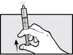 A hand holding a syringe vertically with a