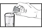 A hand pouring liquid from a small graduated container into a