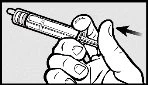 A hand holds a syringe with the thumb pressing downward to activate the mechanism indicated by a black arrow