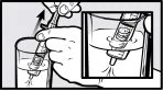 A hand holds a syringe above a glass of