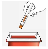 A hand holding a white and orange medical device above a red rectangular container for disposal of biological waste