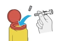 A hand inserting a cylindrical medical device into