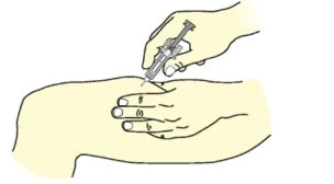A hand holding a syringe inserting the needle into the skin