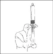 A hand holding a syringe vertically with the needle pointing upwards