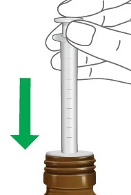 A hand holds a syringe and pushes the plunger downward at the
