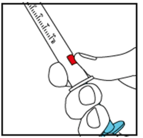 A hand holding a graduated syringe with the thumb pressing down on a red button to activate the injection mechanism