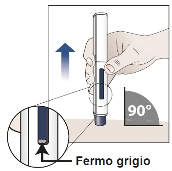 Una mano sostiene una pluma inyectable verticalmente a 90 grados sobre una superficie, con un detalle ampliado que indica el tope gris