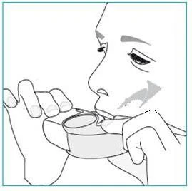 Line drawing of a person holding an inhaler with both hands and positioning it in front of the mouth for