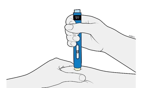 A hand vertically holds a blue medical device to inject it into the skin of the upper arm or thigh