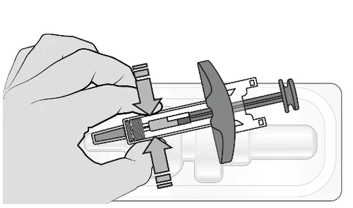 A hand holding a prefilled syringe inserting it into an administration device with arrows indicating downward movement