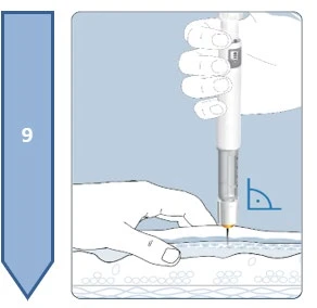A hand holding a vertical injection pen resting the