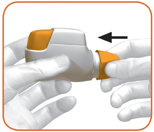 Gloved hands holding a white and orange medical device with a black arrow indicating the insertion movement of a component