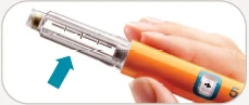 A hand gripping an orange and transparent injection pen with a blue arrow pointing to the upper part of the device
