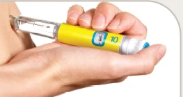 Two hands holding a yellow pen-style medical device with a digital display showing number 10 ready for use