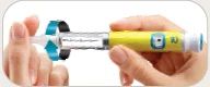 Two hands holding a yellow and transparent injection pen, showing the dosing mechanism and the tip for