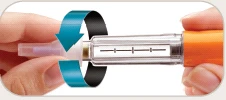Two hands holding a transparent syringe with a curved blue arrow indicating rotational movement to screw on the white tip