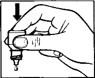 A hand holds a small bottle with a dropper as a drop of liquid descends from it