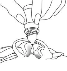 A hand squeezing an eye dropper bottle to release a drop of liquid directly onto the surface of an open eye
