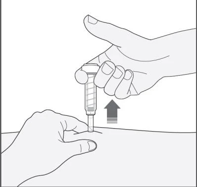 A hand holding a syringe vertically while the