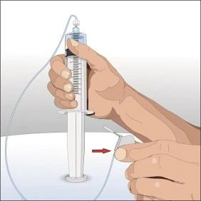 Two hands holding a vertical syringe with an attached tube, and a red arrow indicating the downward direction of movement